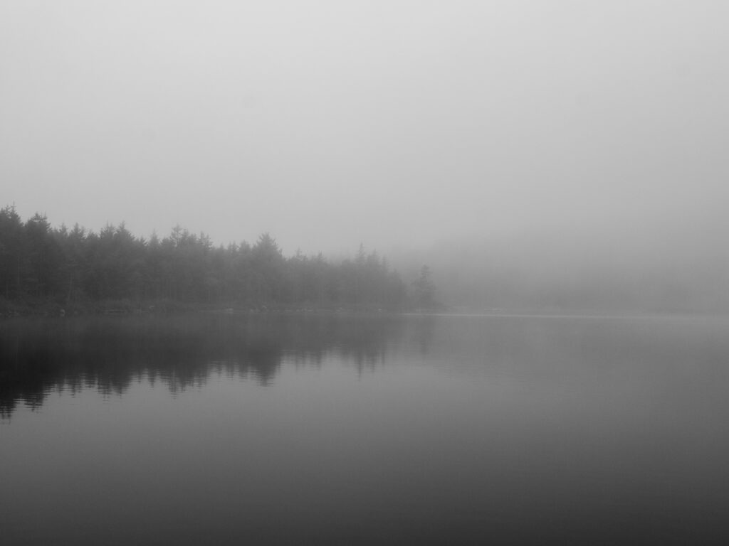 Hushed — black and white long exposure photograph of fog over still water, The Bowl, Acadia National Park, Maine, Brad Emerson