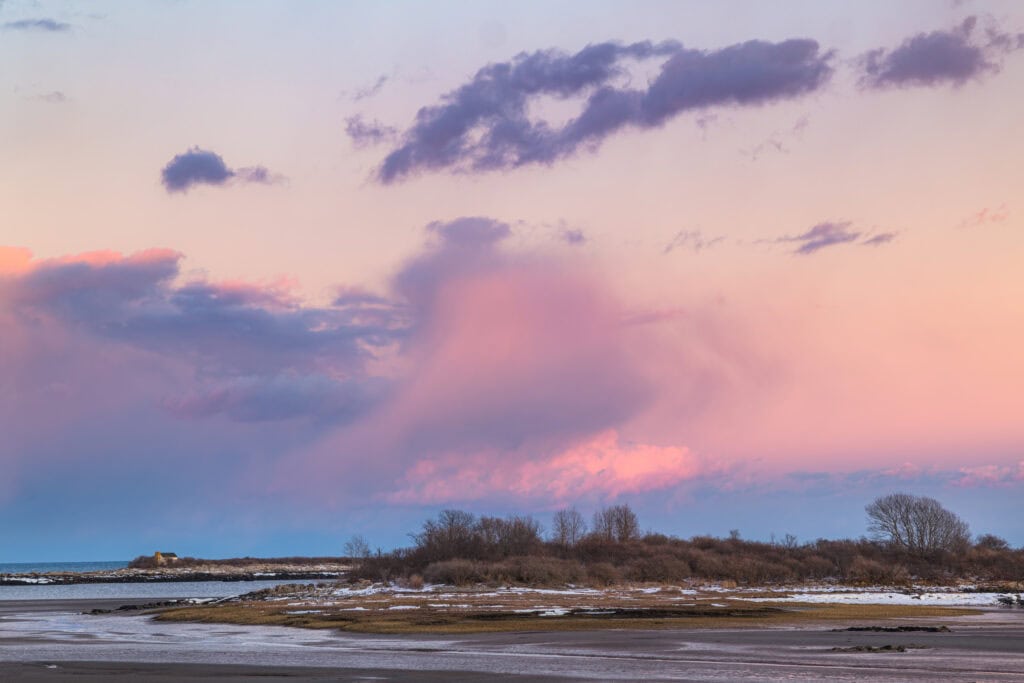 The Last Cottage color photograph of solitary cottage on coastal point under vast pink and lavender winter sky, Cape Porpoise, Maine, fine art landscape photography by Brad Emerson